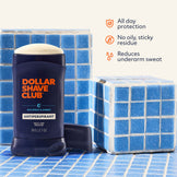 Dollar Shave Club antiperspirant stick on a blue tiled background