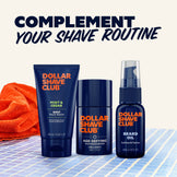 Dollar Shave Club grooming products including face wash, moisturizer, and beard oil on a checkered surface with an orange towel.