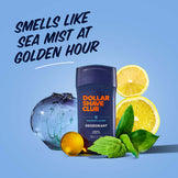 Dollar Shave Club deodorant with lemons, ice, and mint leaves on a blue background