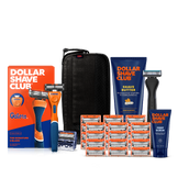 Dollar Shave Club University of Florida grooming kit on a white background. Includes a blue razor handle with the Florida logo, 24 blades, Shave Butter, Prep Scrub, a black 3-in-1 electric trimmer, and a black traveler case.