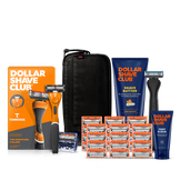 Dollar Shave Club University of Tennessee grooming kit on a white background. Includes an orange razor handle with the Tennessee Volunteers "T" logo, 24 blades, Shave Butter, Prep Scrub, a black 3-in-1 electric trimmer, and a black traveler case.