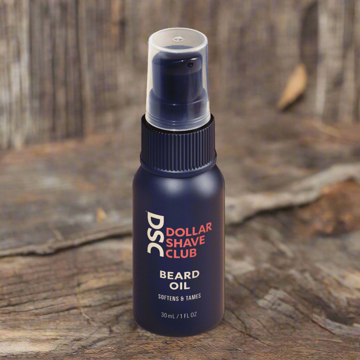 Dollar Shave Club Beard Oil against tan backdrop.