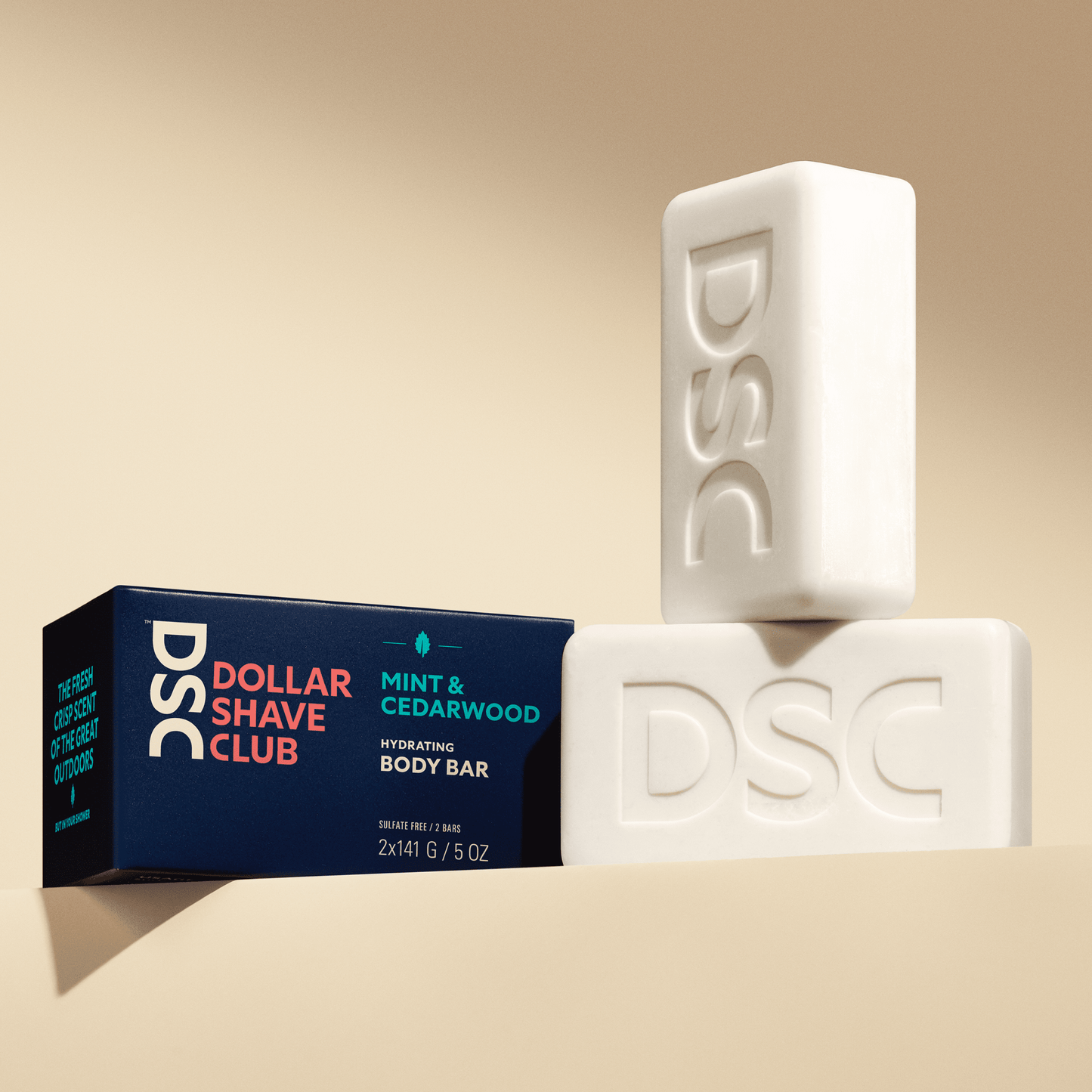 Dollar Shave Club Body Bars Mint Cedarwood against tan backdrop.