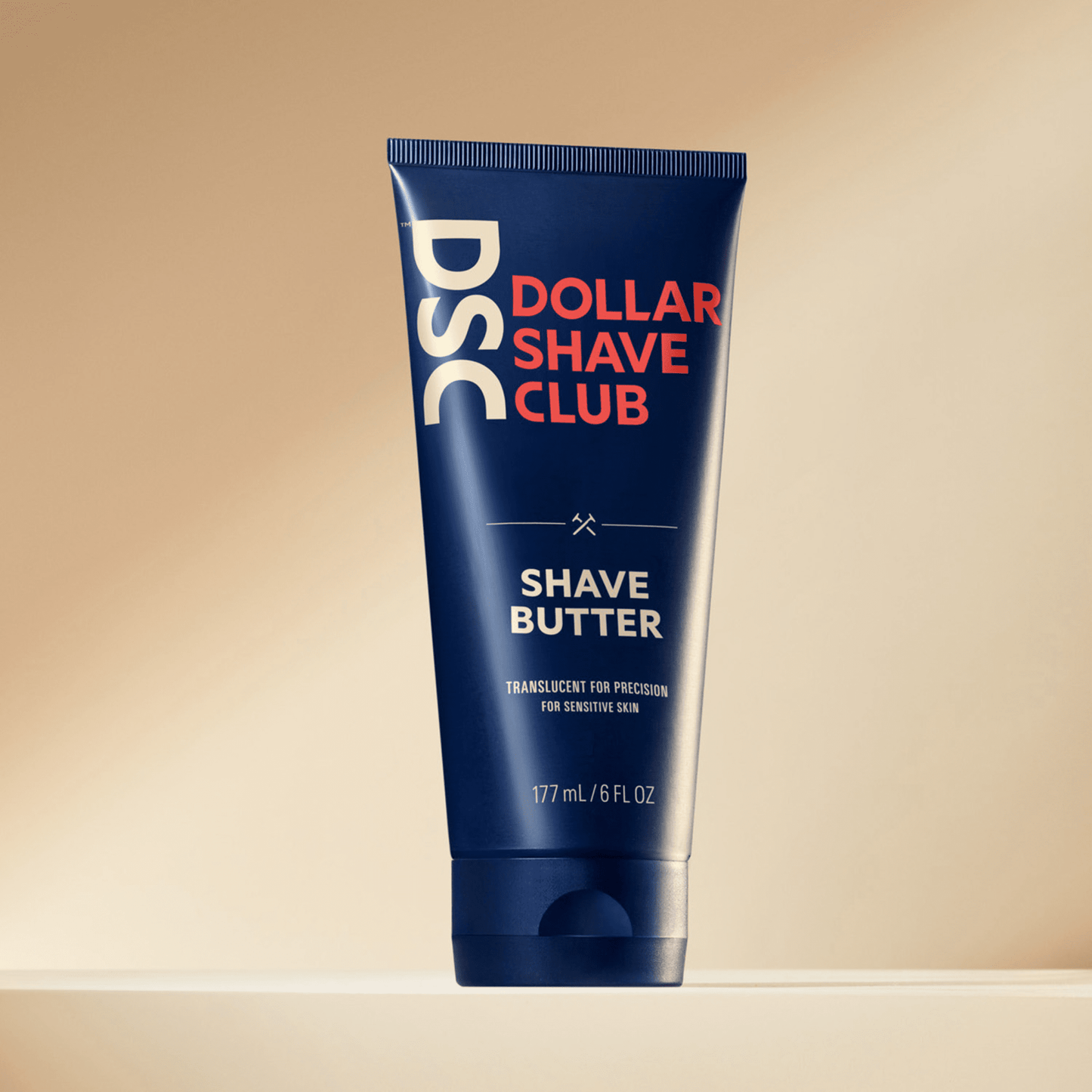Dollar Shave Club Shave Butter product image against tan backdrop.